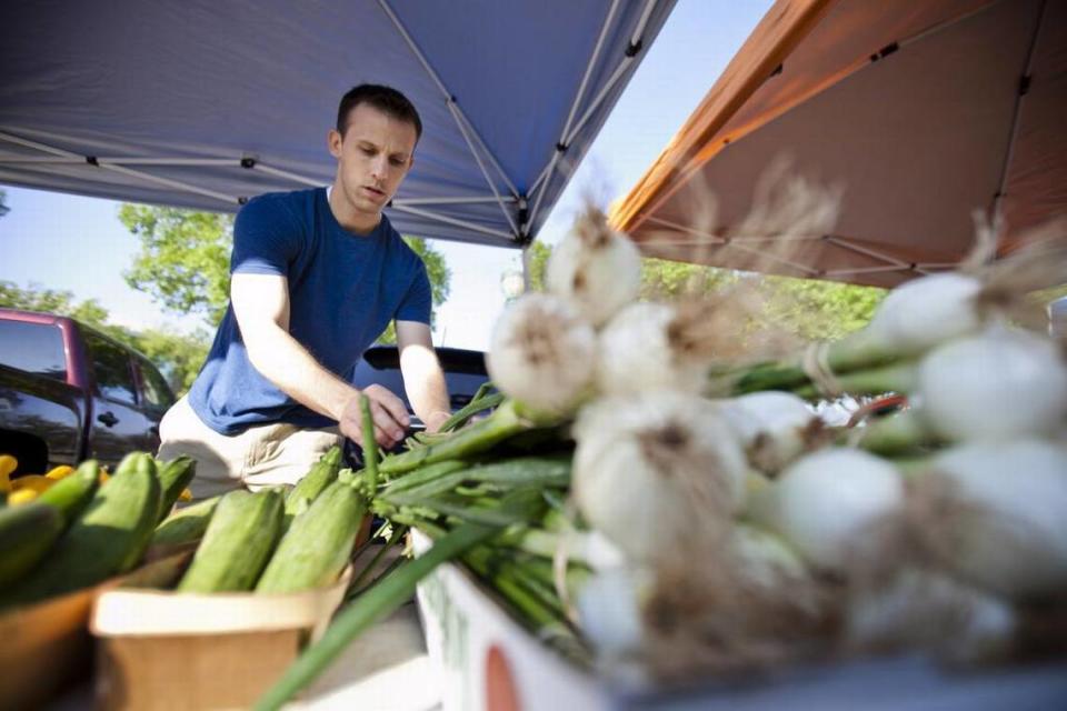 Kramer Copp works at the Denton Creek Farm stand at the Keller Farmers Market.