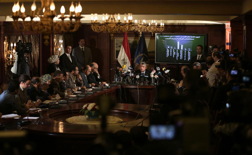 Egypt's Interior Minister Mohammed Ibrahim, center, speaks during a press conference in Cairo, Egypt, Sunday, March 30, 2014. Ibrahim said his agents seized the documents, smuggled out of the presidential palace, before they were leaked to Qatar-based Al-Jazeera network, and the intelligence agency of an Arab country allied with the Muslim Brotherhood. (AP Photo/Hassan Ammar)