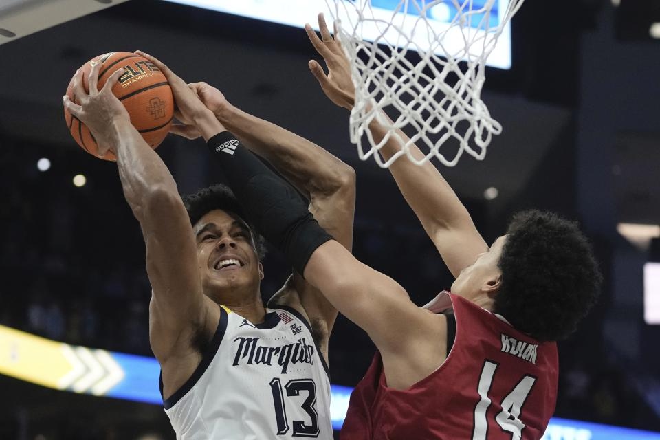 Marquette's Oso Ighodaro is foiled by Northern Illinois's Xavier Amos during the first half of an NCAA college basketball game Monday, Nov. 6, 2023, in Milwaukee. (AP Photo/Morry Gash)