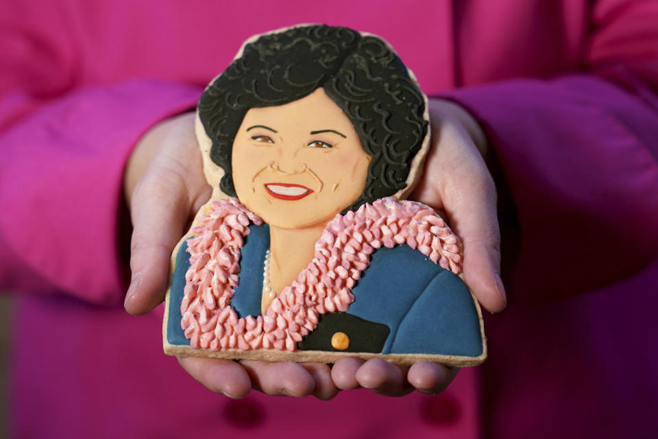 Jasmine Cho holds a cookie portrait of late Hawaii Rep. Patsy Takemoto Mink, the first Asian-American woman to serve in Congress, in Pittsburgh, Pa., Wednesday, May 3, 2023. Cho, a Korean American self-described “cookie activist,” has gained fans over the last several years for her finely detailed cookie mugs of famous and forgotten figures. (AP Photo/Matt Freed)