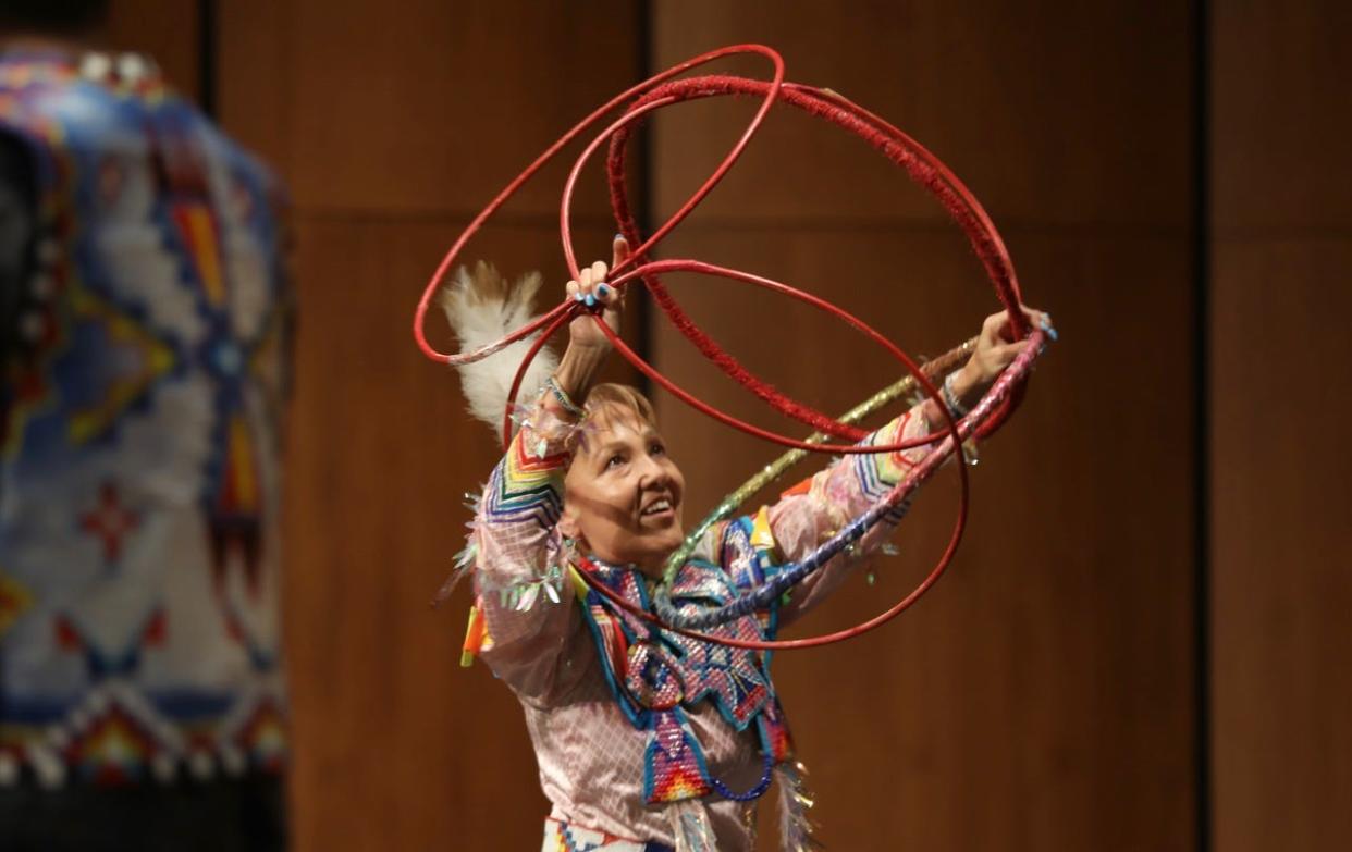With help from her family, Jackie Bird presents a hoop dance to attendees at the Johnson Fine Arts Center at Northern Thursday evening. The dance is an expression of healing and the circle of life. She uses 38 hoops to tell the story of creation. This evening's presentation was the final event celebrating Native American Heritage Month and was jointly sponsored by Northern, Presentation College and Central High School's Native American Student Association.
