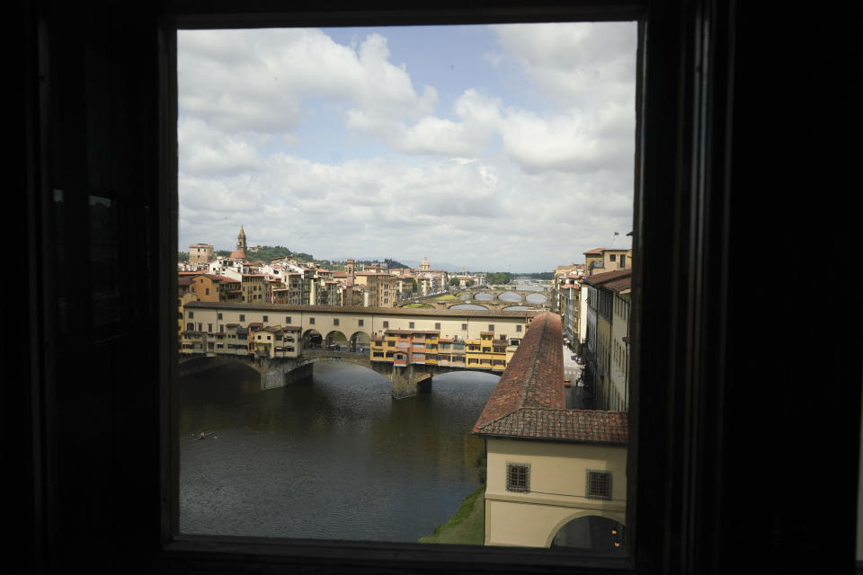 The Ponte Vecchio Old Bridge is seen through a window of the Uffizi Gallery museum, in Florence, Italy, Wednesday, June 3, 2020. Italy opened regional and international borders Wednesday in the final phase of easing its long coronavirus lockdown. (AP Photo/Andrew Medichini)