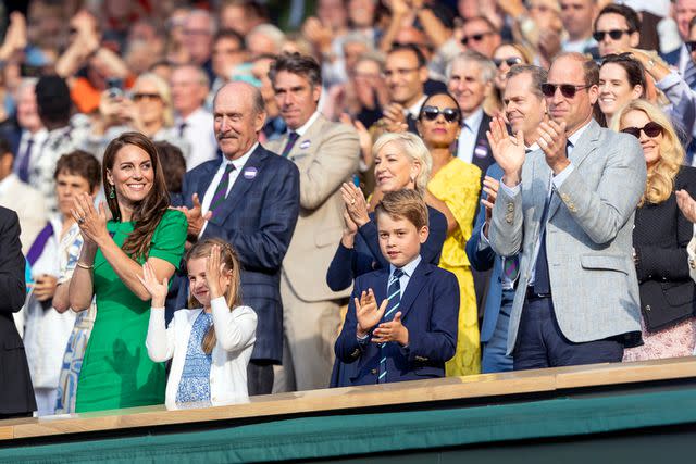 <p>Tim Clayton/Corbis via Getty</p> Princess Kate, Princess Charlotte, Prince George and Prince William of Wales in the Royal Box applaud the victory of Carlos Alcaraz during Wimbledon Championships in July 2023.