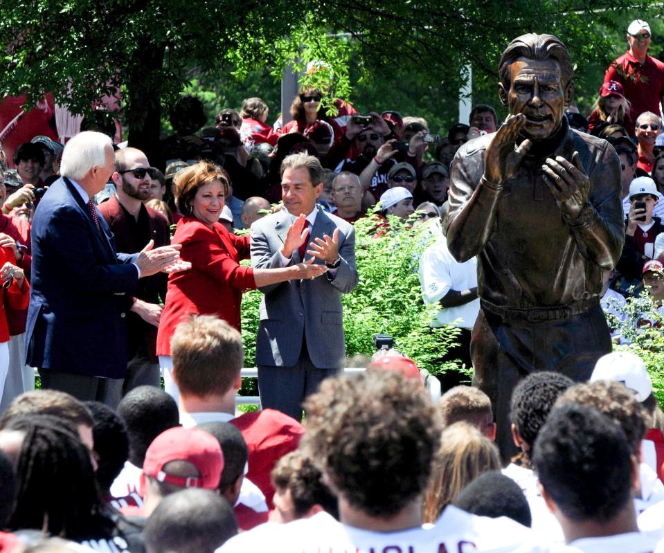 4/16/11 - Tuscaloosa, AL - Terry Saban attempts to form Alabama head coach Nick Saban's hands in the form of those on his statue during the Nick Saban statue unveiling  at the University of Alabama Saturday April 16, 2011. (Jason Harless / The Tuscaloosa News)