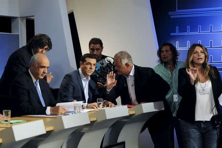 Greece's former prime minister and leader of leftist Syriza party Alexis Tsipras (C) and leader of conservative New Democracy party Evangelos Meimarakis (L) prepare for a political leaders' debate at the headquarters of state broadcaster ERT, in Athens, Greece, September 9, 2015. REUTERS/Michalis Karagiannis