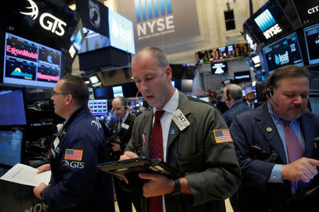 Traders work on the trading floor at the opening of the markets at the New York Stock Exchange (NYSE) in Manhattan, New York City, U.S., February 27, 2017. REUTERS/Andrew Kelly