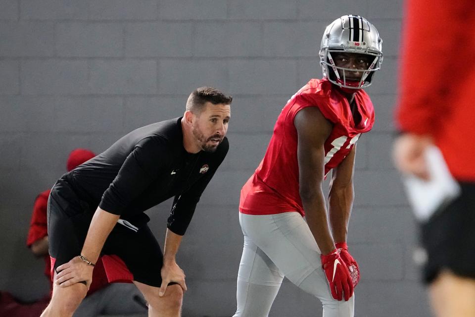 Mar 7, 2023; Columbus, Ohio, USA;  Ohio State Buckeyes wide receiver Carnell Tate lines up beside offensive coordinator Brian Hartline during spring football drills at the Woody Hayes Athletic Center. Mandatory Credit: Adam Cairns-The Columbus Dispatch