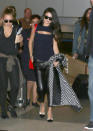 <p>Flying from France to Los Angeles takes half a day and in the past few days Selena Gomez has made multiple outfit changes within 24 hour spans. So it comes as no surprise that she switched up her look at some point a few thousand feet in the air. When she landed at LAX, she arrived in the same baggy leather pants she was spotted at Charles de Gaulle in but traded a white sweater for a black tank top with a peekaboo cutout over her cleavage. She carried a black and white checkered jacket with matching color blocked heels and a red satchel for a pop of color. <i>Photo: Getty Images</i></p>