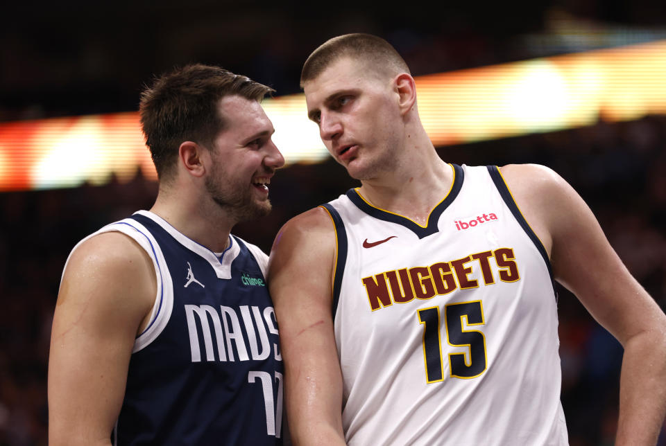 DALLAS, TX - MARCH 17: Luka Doncic #77 of the Dallas Mavericks and Nikola Jokic #15 of the Denver Nuggets talk during a beak in the action in the second half at American Airlines Center on March 17, 2024 in Dallas, Texas. NOTE TO USER: User expressly acknowledges and agrees that, by downloading and or using this photograph, User is consenting to the terms and conditions of the Getty Images License Agreement. (Photo by Ron Jenkins/Getty Images)