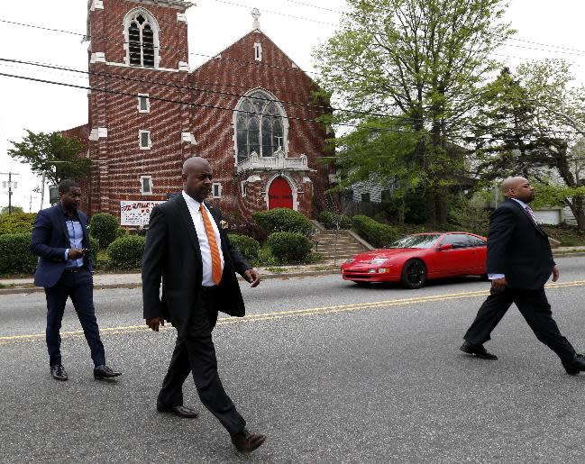 Newark mayoral candidate Ras Baraka, center, leaves St. John's Lutheran Church after casting his vote, Tuesday, May 13, 2014, in Newark, N.J. Tuesday's election will decide whether Baraka, a Newark city councilman, or opponent Shavar Jeffries, a former state assistant attorney general, will take over the seat Cory Booker occupied from 2006 until October 2013, when he won a special election to succeed U.S. Sen. Frank Lautenberg, who died in office. (AP Photo)