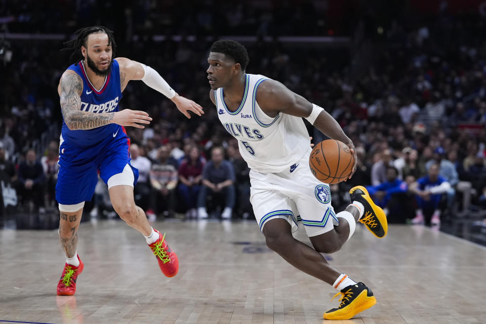 Minnesota Timberwolves guard Anthony Edwards, right, drives against Los Angeles Clippers guard Amir Coffey during the second half of an NBA basketball game, Monday, Feb. 12, 2024, in Los Angeles. (AP Photo/Ryan Sun)