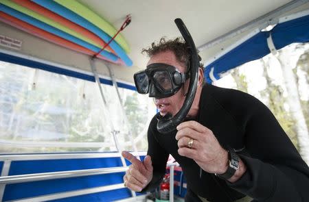 River Ventures' Captain Mike Birns delivers instructions to the guest on board his boat as they head to snorkel with the manatees at Three Sisters Springs in Crystal River, Florida January 15, 2015. REUTERS/Scott Audette