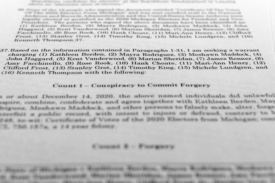 The affidavit in support of an arrest warrant for 16 fake Republican electors for Donald Trump in the 2020 presidential election in Michigan is photographed Tuesday, July 18, 2023. Michigan Attorney General Dana Nessel has charged 16 Republicans with multiple felonies after they are alleged to have submitted false certificates stating they were the state's presidential electors despite Joe Biden's 154,000-vote victory in 2020. (AP Photo/Jon Elswick)