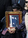 Friends and relatives of the victims of 9/11 gather for a ceremony marking the 10th anniversary of the attacks at the National September 11 Memorial at the World Trade Center site, Sunday, Sept. 11, 2011, in New York. (AP Photo/Jason DeCrow)