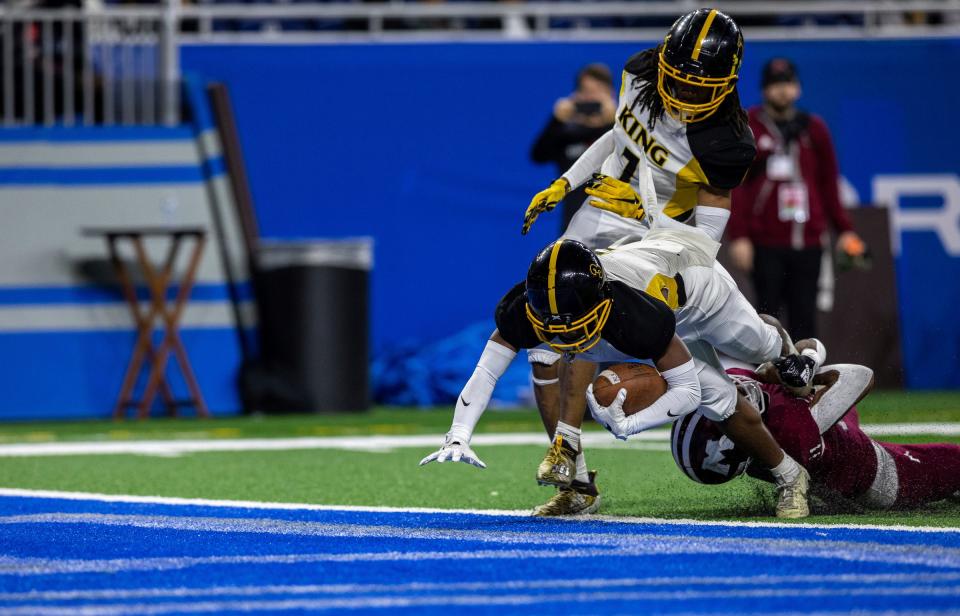 Detroit King's Sterling Anderson Jr. scores a touchdown against a Muskegon defender during the first half of the Division 3 football final at Ford Field on Saturday, Nov. 26, 2022.