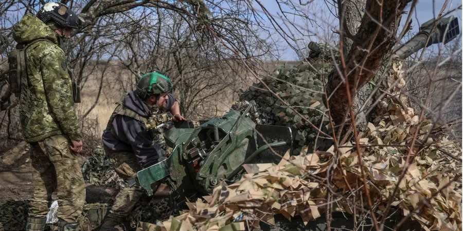 Ukrainian servicemen fire a 120-mm 2B16 Nona-K mortar near Bakhmut, March 8, 2024