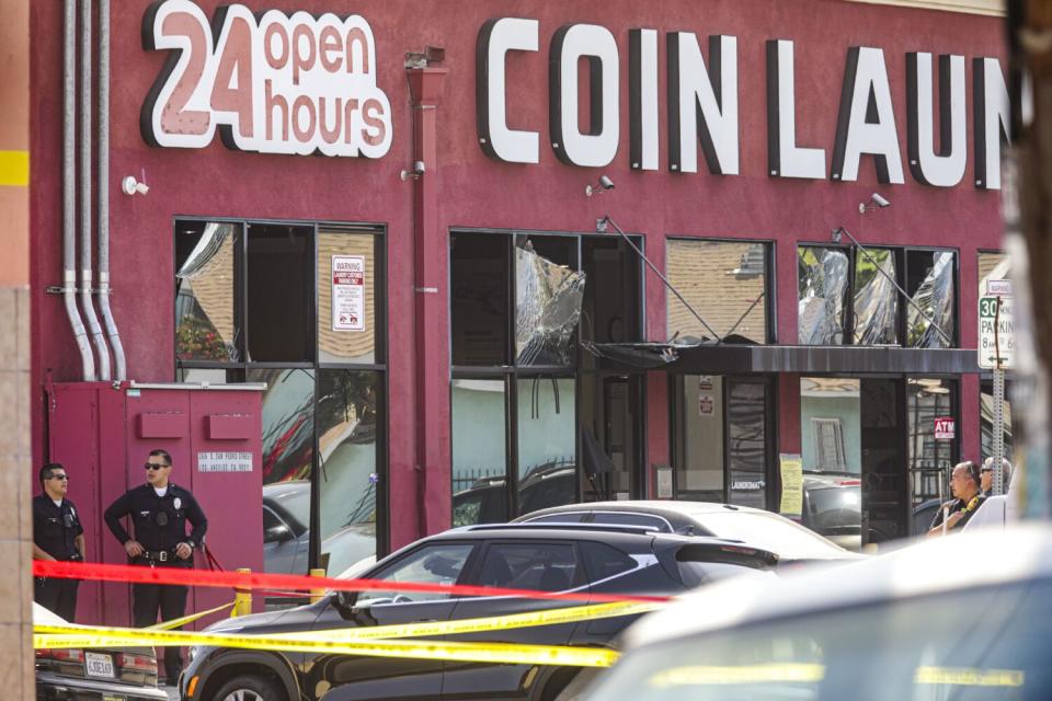 A damaged building that says "Coin Laundry" on the front