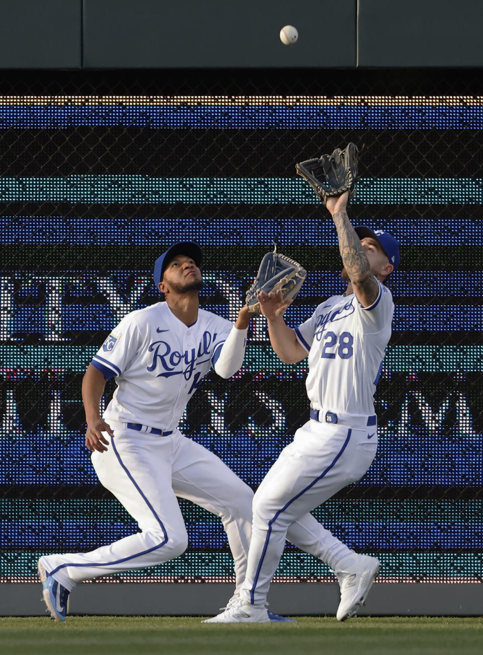 Kansas City Royals left fielder Edward Olivares (14) and center fielder Kyle Isbel (28) converge on a fly ball from Baltimore Orioles batter Ryan Mountcastle for an out during the third inning of a baseball game in Kansas City, Mo., Wednesday, May 3, 2023. (AP Photo/Colin E. Braley)