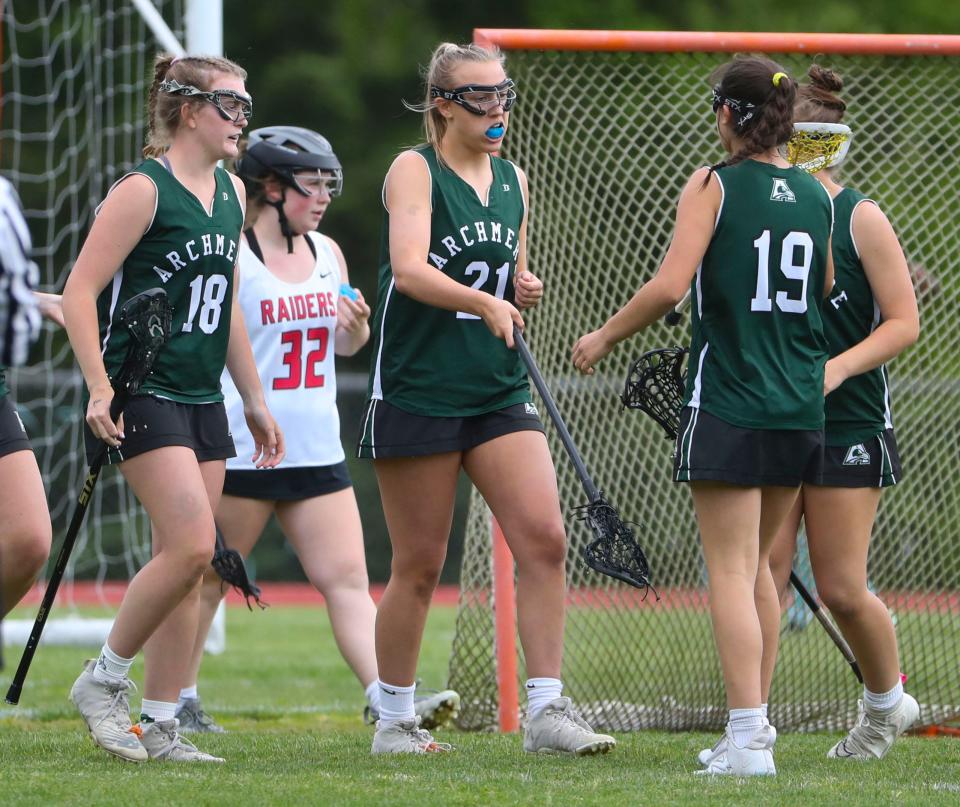 Archmere's Sara Denning (21) receives congratulations from teammates after one of her four goals in the Auks' 13-11 win in a visit to Serviam Field, Friday, May 5, 2023.