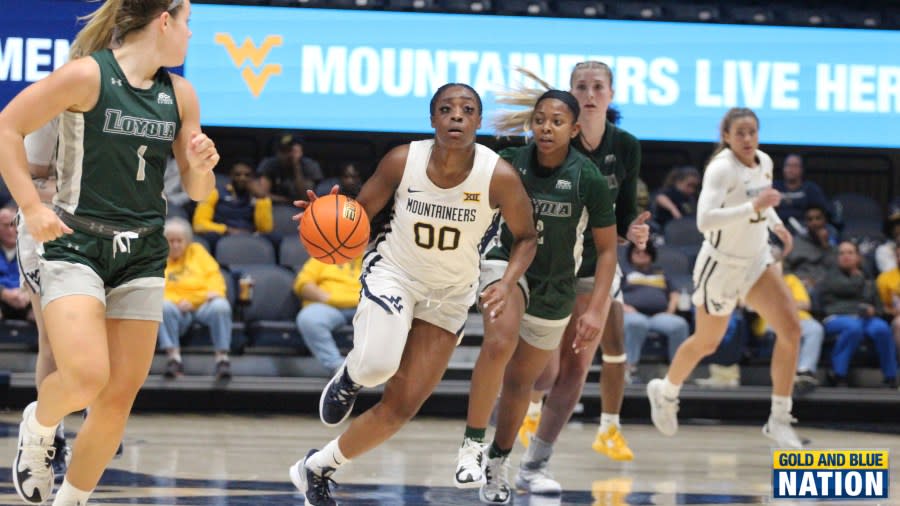 Fifth-year senior Jayla Hemingway dribbles through traffic against Loyola (Md). (Photo Ryan Decker, Gold and Blue Nation)