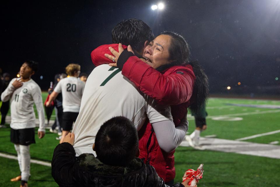 Estacada's Gener Pinto-Dominguez (7) hugs his mother, Jeanette Pinto, after winning the first round of Class 4A OSAA state playoffs on Wednesday, Nov. 1, 2023, at Stayton High School in Stayton, Ore.