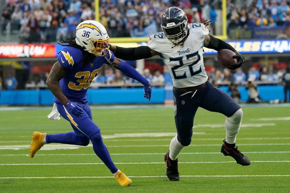 Tennessee Titans running back Derrick Henry (22) runs against Los Angeles Chargers cornerback Ja'Sir Taylor (36) during the first half of an NFL football game in Inglewood, Calif., Sunday, Dec. 18, 2022.