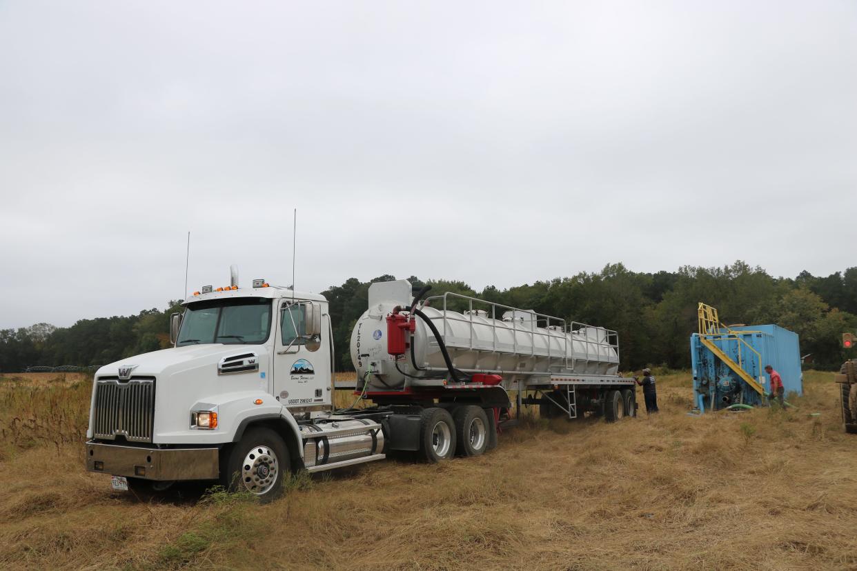 A Burns Farms tanker truck unloads chicken "sludge," a smelly rendered product made from poultry processing leftovers like chicken heads, offal, feathers and blood, into a blue holding vessel near a Burns cornfield Thursday, Oct. 3, 2019. The product is applied to the fields as a nutrient-rich fertilizer.