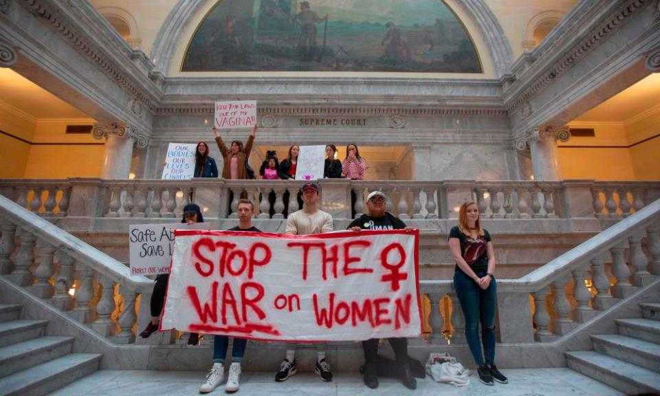 Protesters hold signs at a rally to oppose abortion bans throughout the United States, in Salt Lake City, Utah on 21 May 2019.