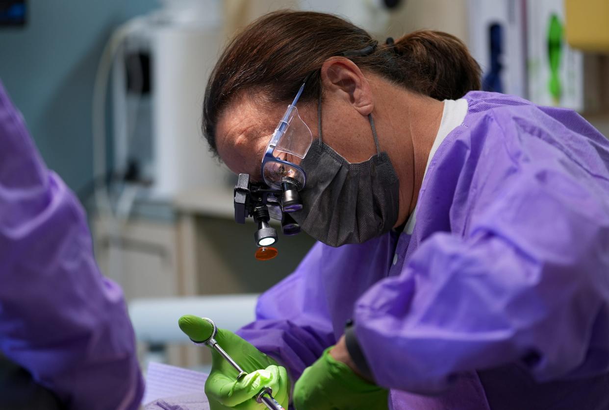 Dr. Jill Burns prepares to clean and fill a cavity for Jessica Brock (not pictured) on Monday, August 21, 2023, at West Main Family Dental in Richmond, Ind. Brock found the office for her and her son after a difficult search for a practice that accepts Medicaid insurance.