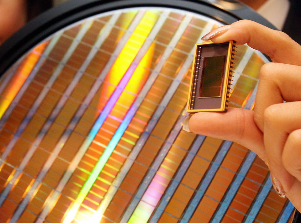 An employee of Samsung Electronics shows the world's first 30-nanometer 64-gigabit NAND flash memory device during a news conference in Seoul, 23 October 2007.  Samsung Electronics said it has developed the world's most powerful memory chip, which could help create a memory card capable of storing 80 DVD movies, adding the new product would create a new 20-billion USD market until 2011 by offering fresh applications for various multimedia items such as mobile handsets, digital cameras and MP3 players.  AFP PHOTO/KIM JAE-HWAN (Photo credit should read KIM JAE-HWAN/AFP/Getty Images)