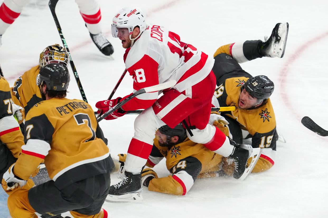 Detroit Red Wings center Andrew Copp (18) skates past Vegas Golden Knights defenseman Nicolas Hague (14) and Vegas Golden Knights center Brendan Brisson (19) during the third period at T-Mobile Arena in Las Vegas on Saturday, March 9, 2024.
