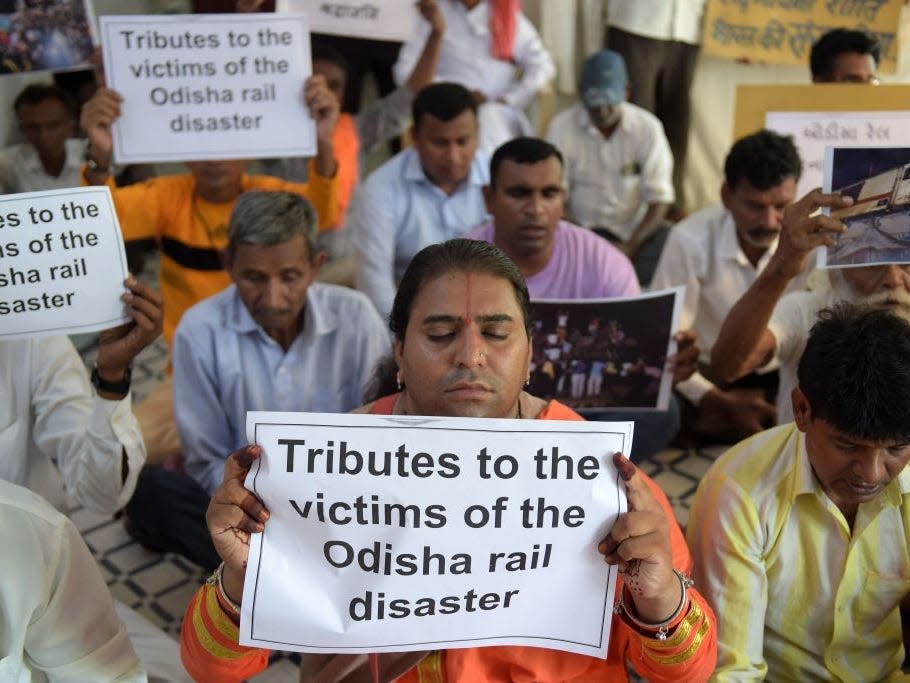 People offer prayers for the victims and survivors of the three-train collision near Balasore in the eastern state of Odisha, at the Kabir Ashram in Ahmedabad on June 3, 2023.