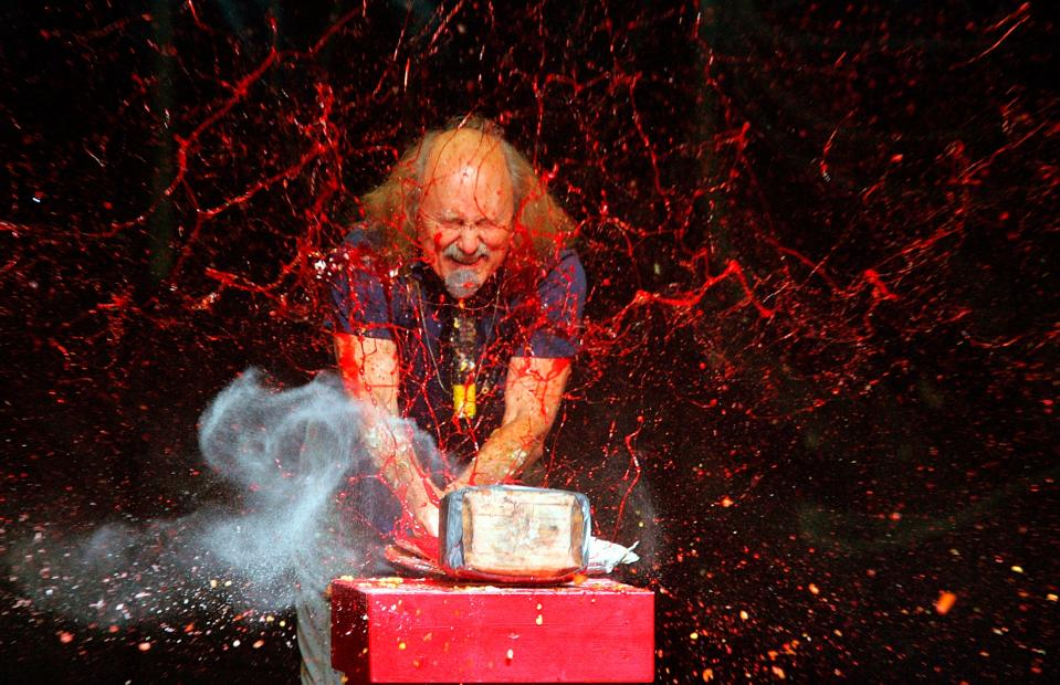 Comedian Gallagher smashes strawberry syrup and flour at the end of his performance at the Five Flags Theater in Dubuque, Iowa on In this Nov. 18, 2006. Gallagher, the smash-’em-up comedian who left a trail of laughter, anger and shattered watermelons over a decades-long career, died Friday at his home in Palm Springs, Calif., after a brief illness. He was 76.