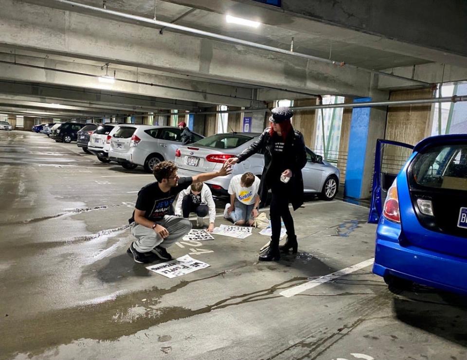 Vanderbilt University students waterproof their protest signs before heading out in the rain for a rally outside of the Capitol on Thursday, April 6, 2023.