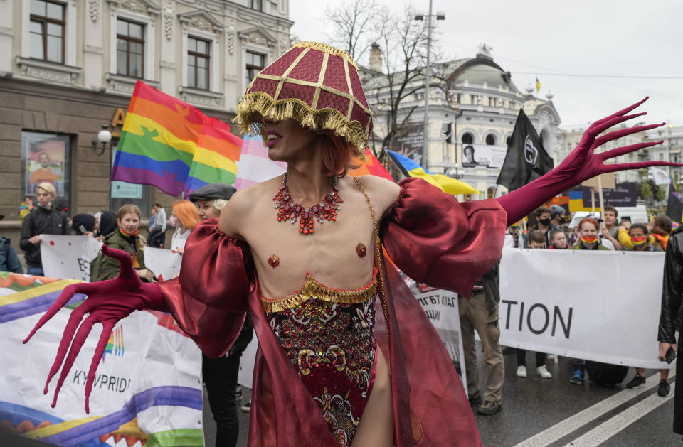 People take part in the annual Gay Pride parade, under the protection of riot police in Kyiv, Ukraine, Sunday, Sept. 19, 2021. Around five thousand LGBT activists and associations paraded in the center of Kyiv. (AP Photo/Efrem Lukatsky)