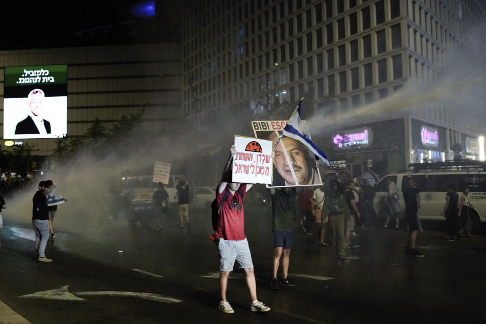 Police use water cannon to disperse demonstrators during a protest against Israeli Prime Minister Benjamin Netanyahu's government, and calling for the release of hostages held in the Gaza Strip by the Hamas militant group, in Tel Aviv, Israel, Saturday, May 18, 2024. (AP Photo/Leo Correa)