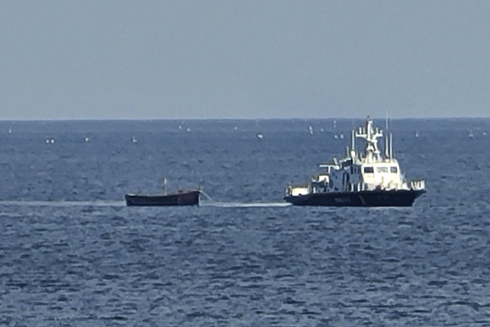 A small wooden boat is towed into a port in Yangyang, South Korea, Tuesday, Oct. 24, 2023. Four suspected North Korean defectors were found in the small wooden boat near the two Koreas' sea border Tuesday, South Korean officials said. (Park Young-seo/Yonhap via AP)