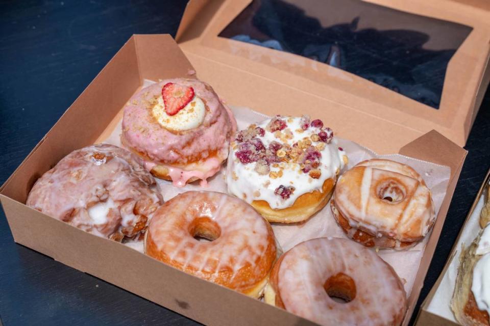 Beyond Amazing Donuts flavors clockwise from left: apple fritter, strawberry cheesecake, raspberry coffee cake, lemon buttermilk old-fashioned and two vanilla glazed.