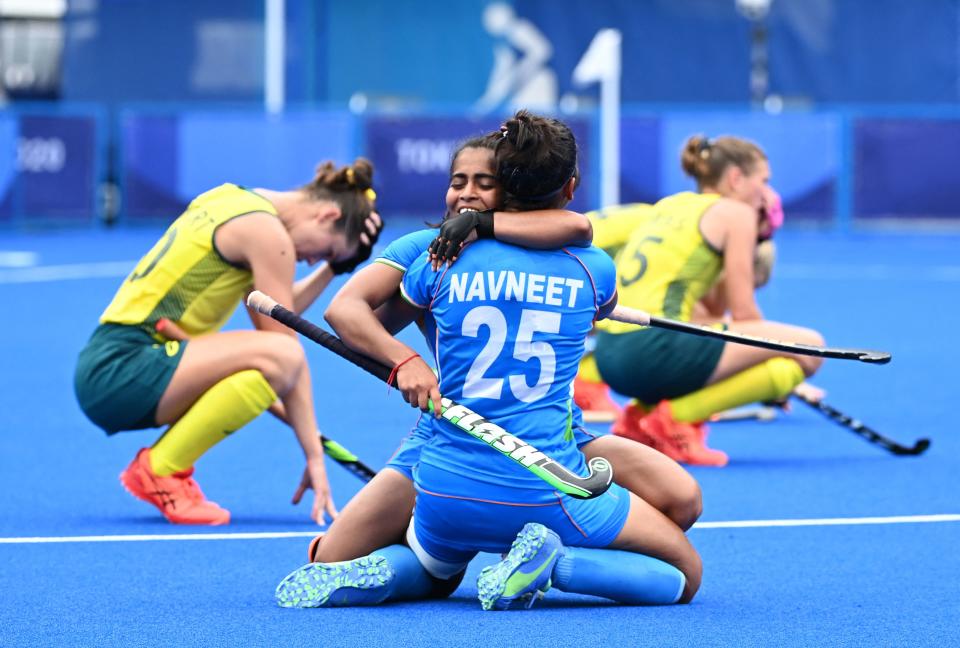 India's Neha (L) and Navneet Kaur celebrate after defeating Australia 1-0 in their women's quarter-final match of the Tokyo 2020 Olympic Games field hockey competition, at the Oi Hockey Stadium in Tokyo, on August 2, 2021. (Photo by CHARLY TRIBALLEAU / AFP) (Photo by CHARLY TRIBALLEAU/AFP via Getty Images)