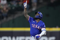 Texas Rangers' Adolis García celebrates after hitting an RBI single during the first inning of a baseball game against the Houston Astros Friday, April 12, 2024, in Houston. (AP Photo/Kevin M. Cox)