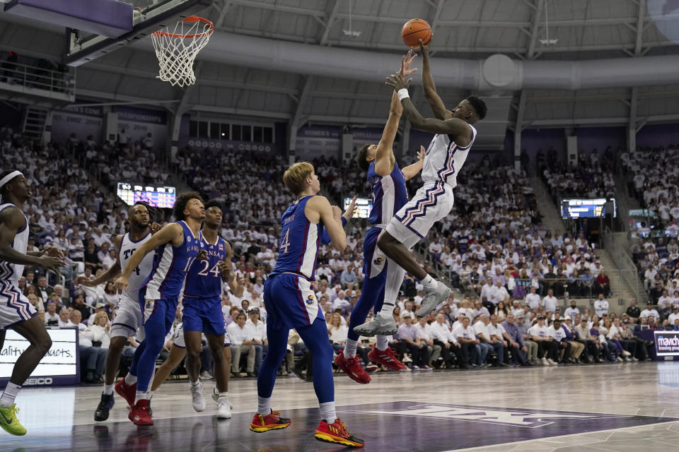 TCU guard Damion Baugh, right, shoots as Kansas' Kevin McCullar Jr., second from right, defends in the second half of an NCAA college basketball game, Monday, Feb. 20, 2023, in Fort Worth, Texas. (AP Photo/Tony Gutierrez)