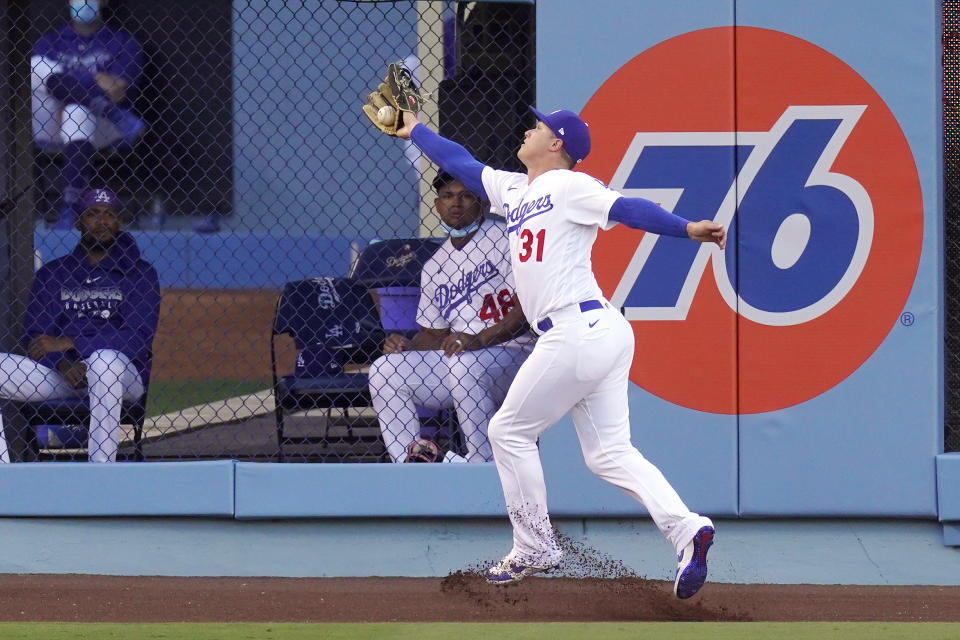 Los Angeles Dodgers left fielder Joc Pederson makes a catch on a ball hit by San Diego Padres' Trent Grisham during the first inning of a baseball game Monday, Aug. 10, 2020, in Los Angeles. (AP Photo/Mark J. Terrill)