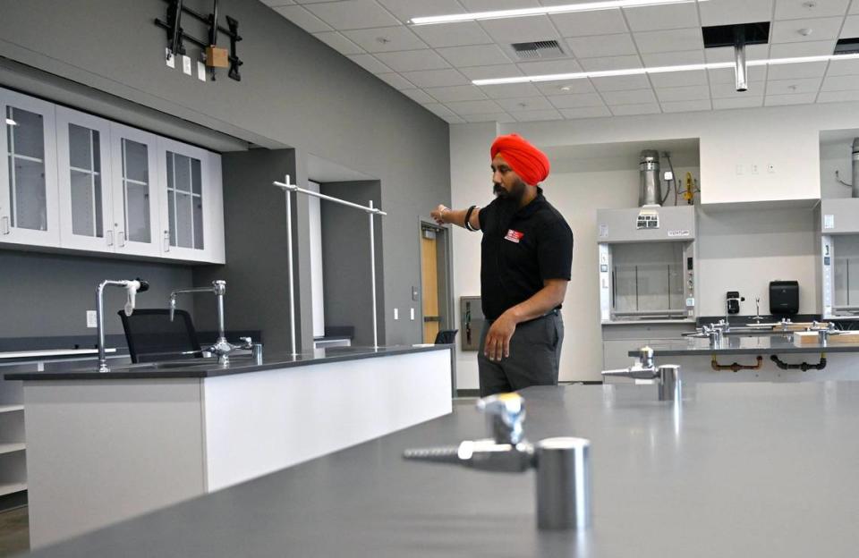 Gurminder Sangha, a dean at the satellite campus, shows a science lab during a tour of Fresno City College’s new West Fresno campus still under construction on Thursday, June 22, 2023.