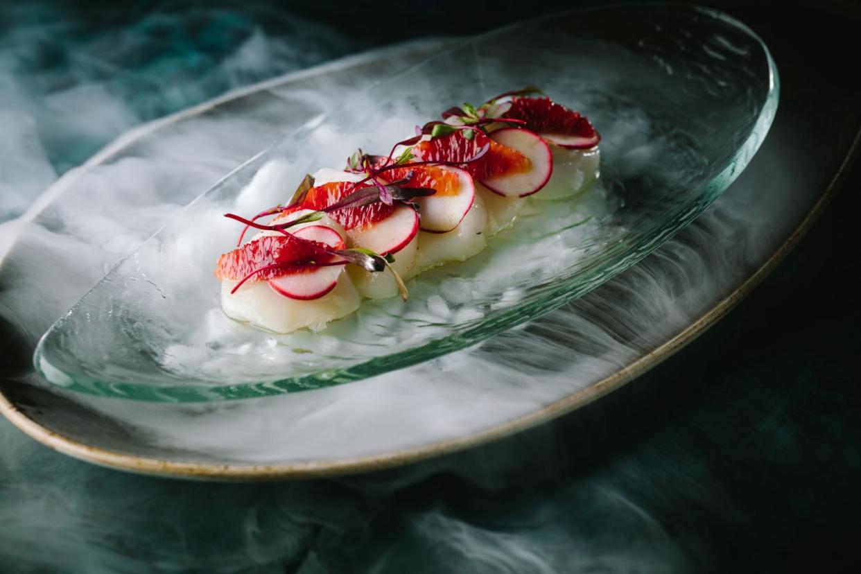 Smartly dressed scallop crudo is served at the new Blue Dog Cookhouse and Bar in Boca Raton.