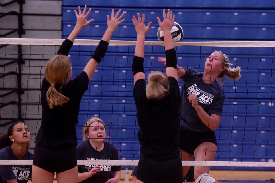 Granville's Grace Hotchkiss spikes the ball at Johnstown defenders during summer scrimmages in the Blue Aces gym on Thursday, July 21, 2022.