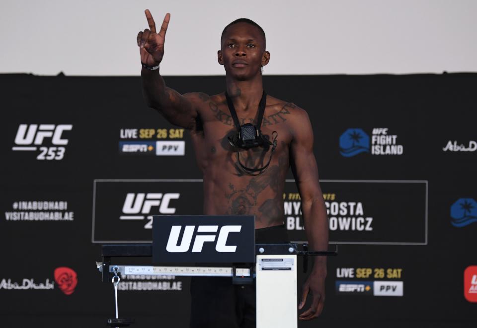 Israel Adesanya of Nigeria poses on the scale during the UFC 253 weigh-in  (Zuffa/LLC via Getty Images)