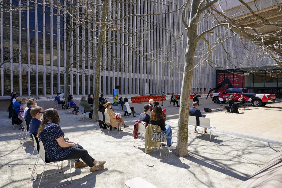 Members of the New York Philharmonic perform on the Lincoln Center campus as part of Restart Stages at Lincoln Center, Wednesday, April 7, 2021, in New York. Members of the New York Philharmonic gave an outdoor concert at Lincoln Center for heath care workers, 13 months after the novel coronavirus pandemic decimated their season. (AP Photo/Mary Altaffer)