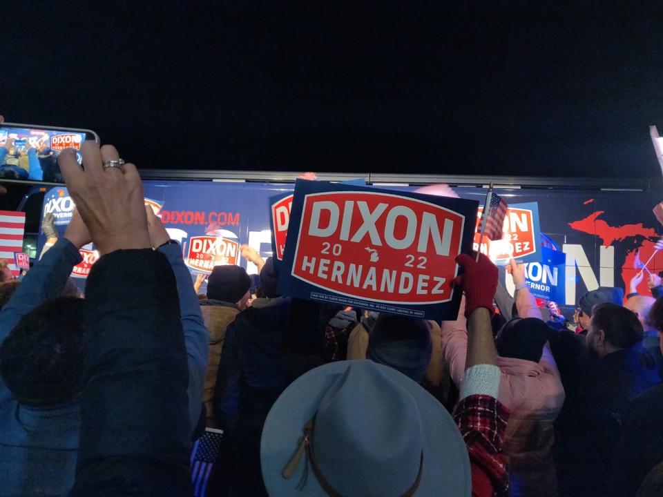 A Michigan Republican waves a Dixon-Hernandez 2022 sign during a campaign rally in Grand Rapids, Michigan on November 7, 2022.