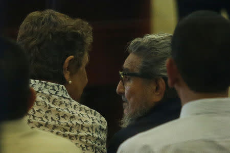 Former Shining Path leader Abimael Guzman talks to his wife and second-in-command Elena Iparraguirre at a trial at a high security naval prison in Lima February 28, 2017. REUTERS/Guadalupe Pardo