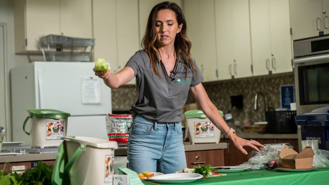 Jennifer Claiborne, program manager Sacramento County Waste Management and Recycling, demonstrates Thursday how to separate food scraps into a kitchen container for the new curbside organic service that starts in July. Claiborne said that its important to always separate any plastic, tags and twist ties from organic material.